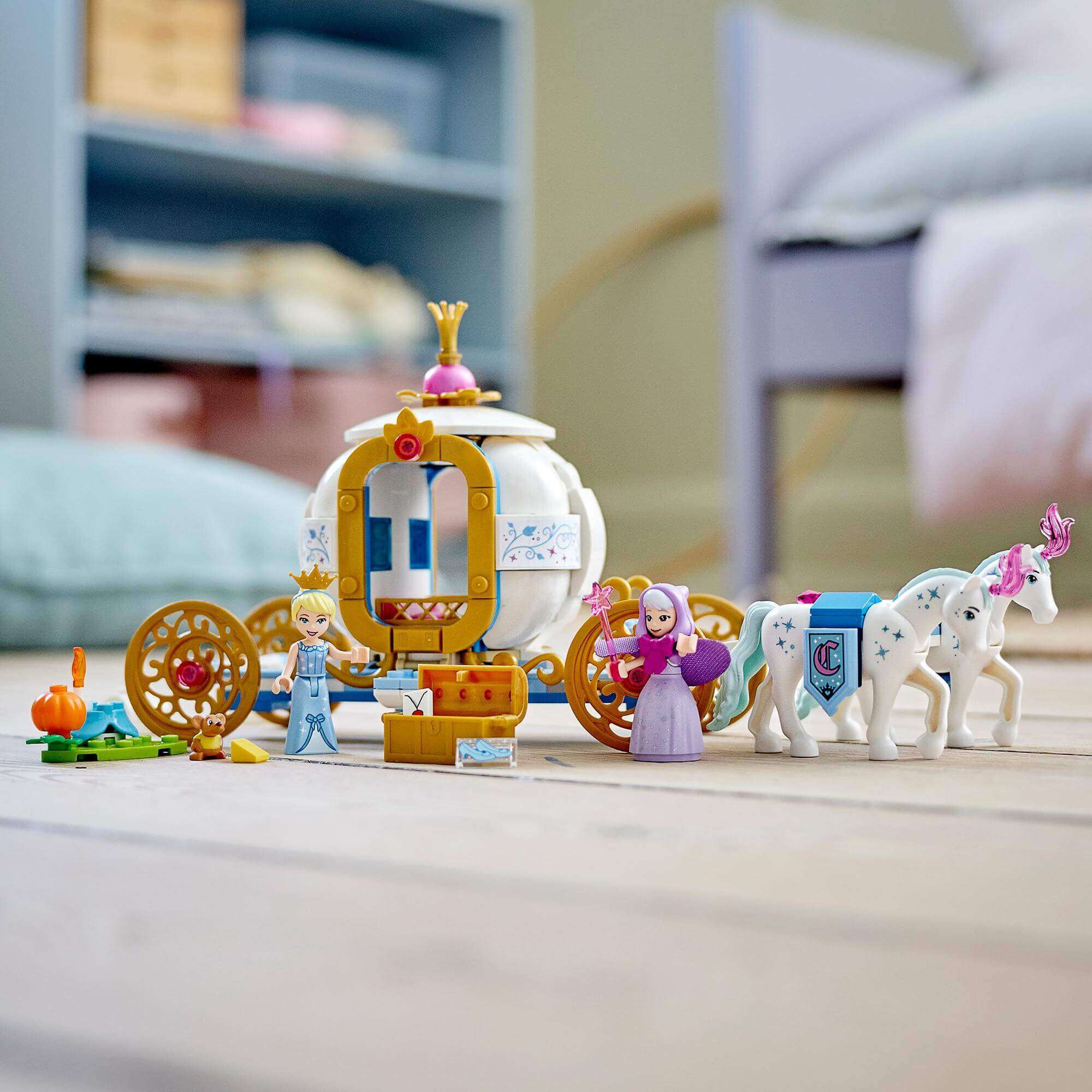 LEGO Disney Cinderella's Royal Carriage Toy set with minidoll figures, carriage, and horse figures on a wooden floor.