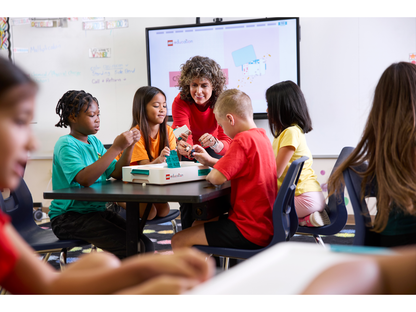 Students engaged in hands-on science learning with LEGO® Education kits in a collaborative classroom setting.