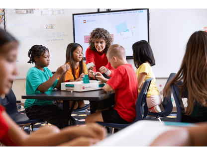 Students engaging in hands-on learning with LEGO® Education Science kits in a classroom setting.