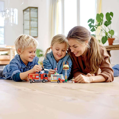 Children and mother playing with LEGO City Burger Bar Fire Rescue Engine 60214 toy on the floor.