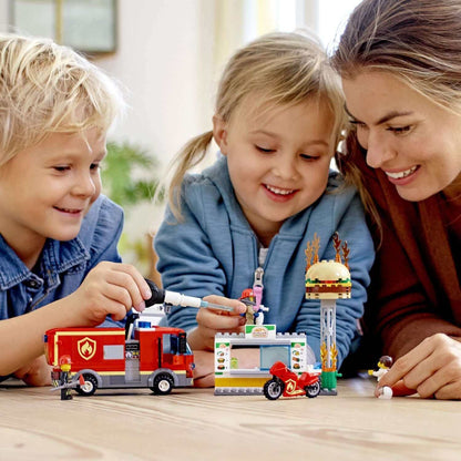 Kids and a mom playing with LEGO® City Burger Bar Fire Rescue Engine Toy 60214, enjoying imaginative play.