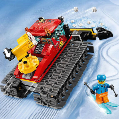 LEGO® City Snow Groomer Toy 60222 with plough, featuring a skier and snow-covered background.