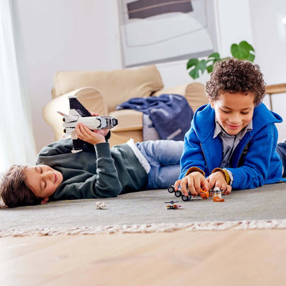 Two children playing with LEGO® City Mars Research Shuttle and space toys on a cozy rug indoors.