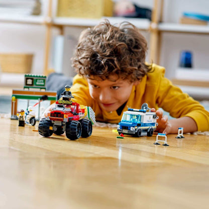 Child playing with LEGO® City Police Monster Truck Heist set, featuring a monster truck and police vehicles on the floor.