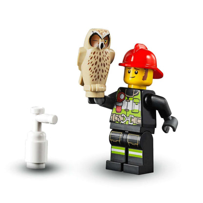LEGO® City fireman minifigure holding an owl, part of the forest fire buggy toy set 60247 for kids.