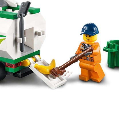 LEGO City Street Sweeper toy with a minifigure using a broom near a green trash bin.