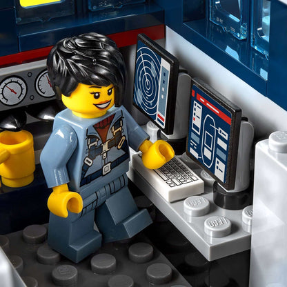 LEGO City Ocean Exploration Ship playset with a minifigure operating computers and controls in the cockpit.