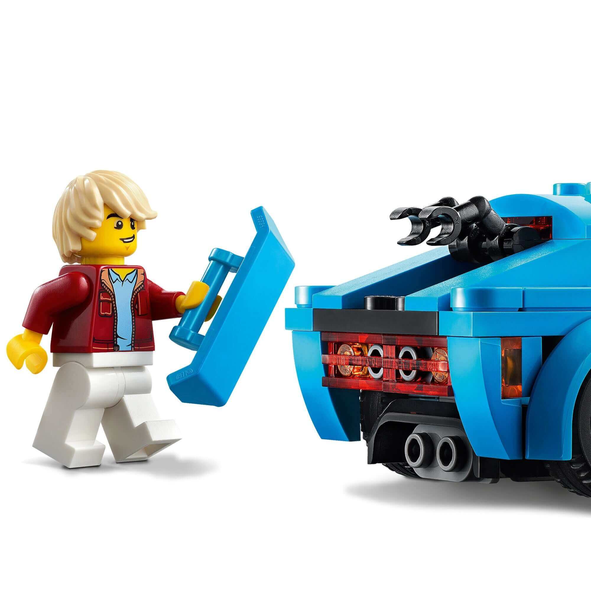 LEGO City Sports Car 60285 with minifigure driver opening the trunk, featuring sporty design and details.