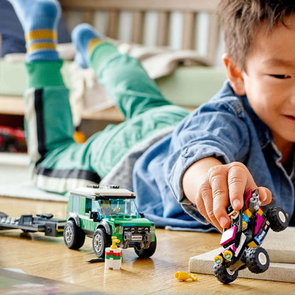 Child playing with LEGO® City Race Buggy Transporter set, featuring off-roader and race buggy on the floor.