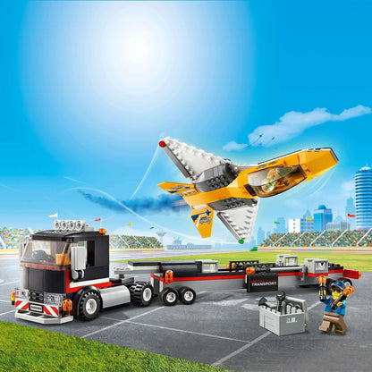LEGO City Airshow Jet Transporter Toy 60289 featuring a jet, transporter truck, and two minifigures in a vibrant playset scene.