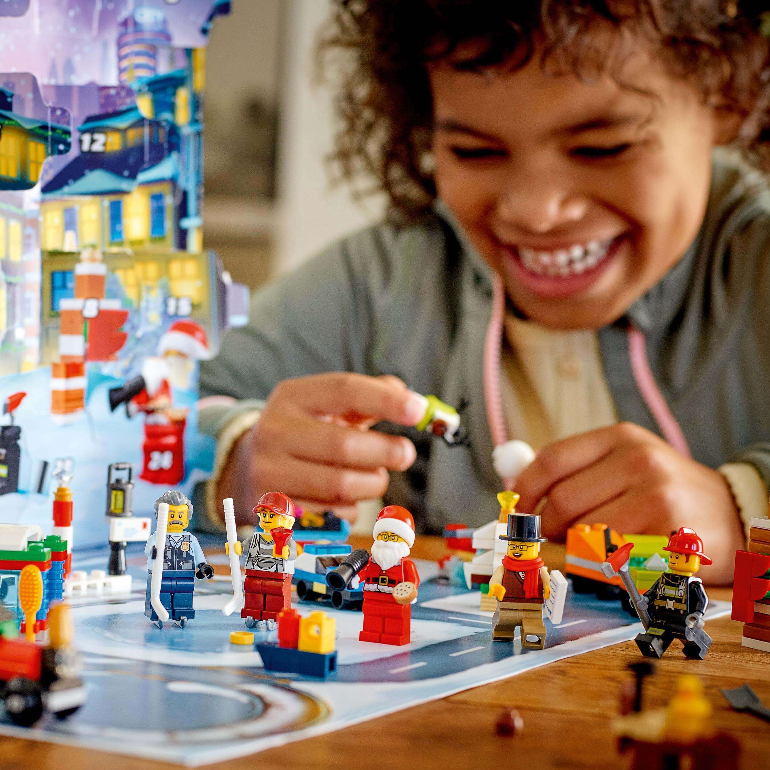 Child enjoying the LEGO City Advent Calendar with festive mini-builds and characters, counting down to Christmas.