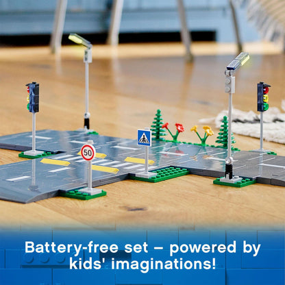 LEGO® City Road Plates Set 60304 featuring streetlights, traffic lights, and road signs for imaginative play.