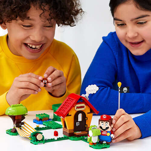 Kids playing with LEGO® Super Mario™ Mario's House & Yoshi Expansion Set, enjoying imaginative play and fun.