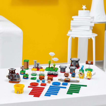 Colorful LEGO® Super Mario Master Adventure Maker Set 71380 components displayed on a white table for creative play.