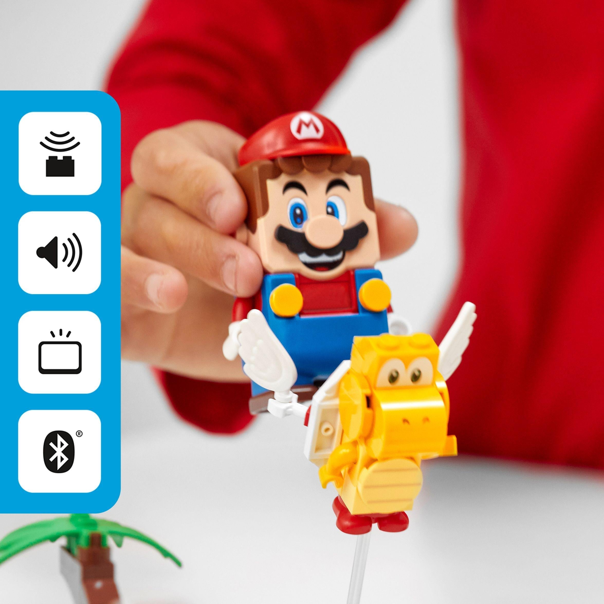 Child playing with LEGO® Super Mario figure and character in the Poison Swamp Expansion Set 71383.