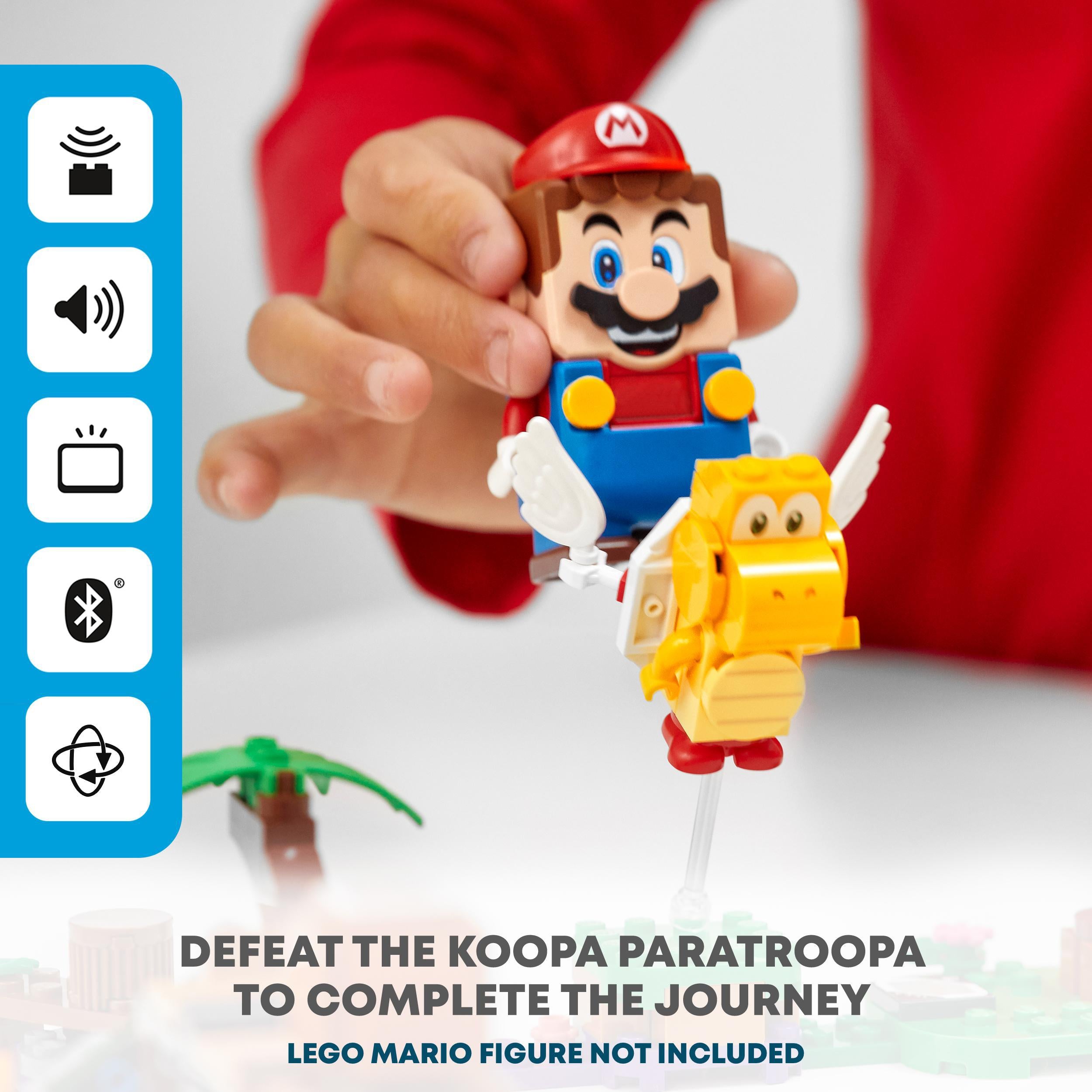 Child playing with LEGO® Super Mario battling Koopa Paratroopa in Poison Swamp Expansion Set 71383.