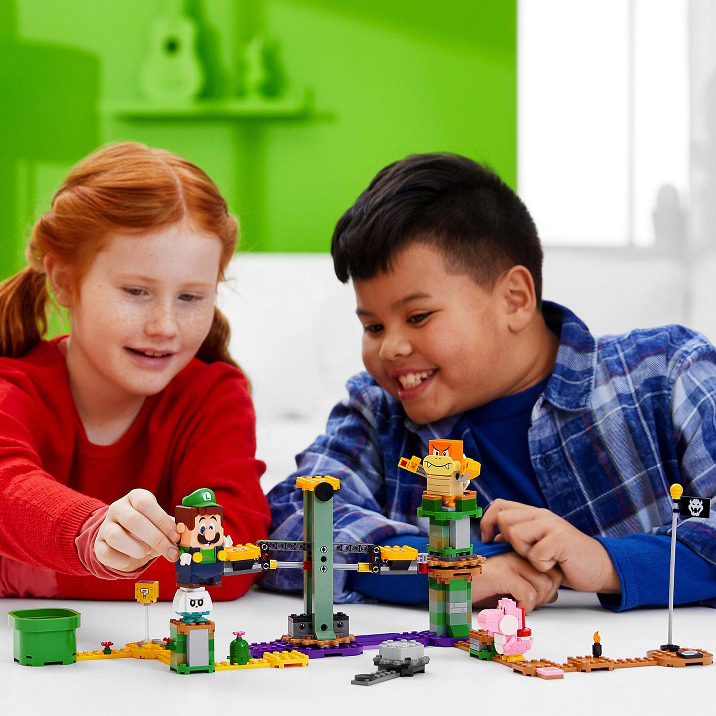 Kids playing with LEGO® Super Mario Luigi Starter Course, enjoying interactive adventures with LEGO® Luigi figure.