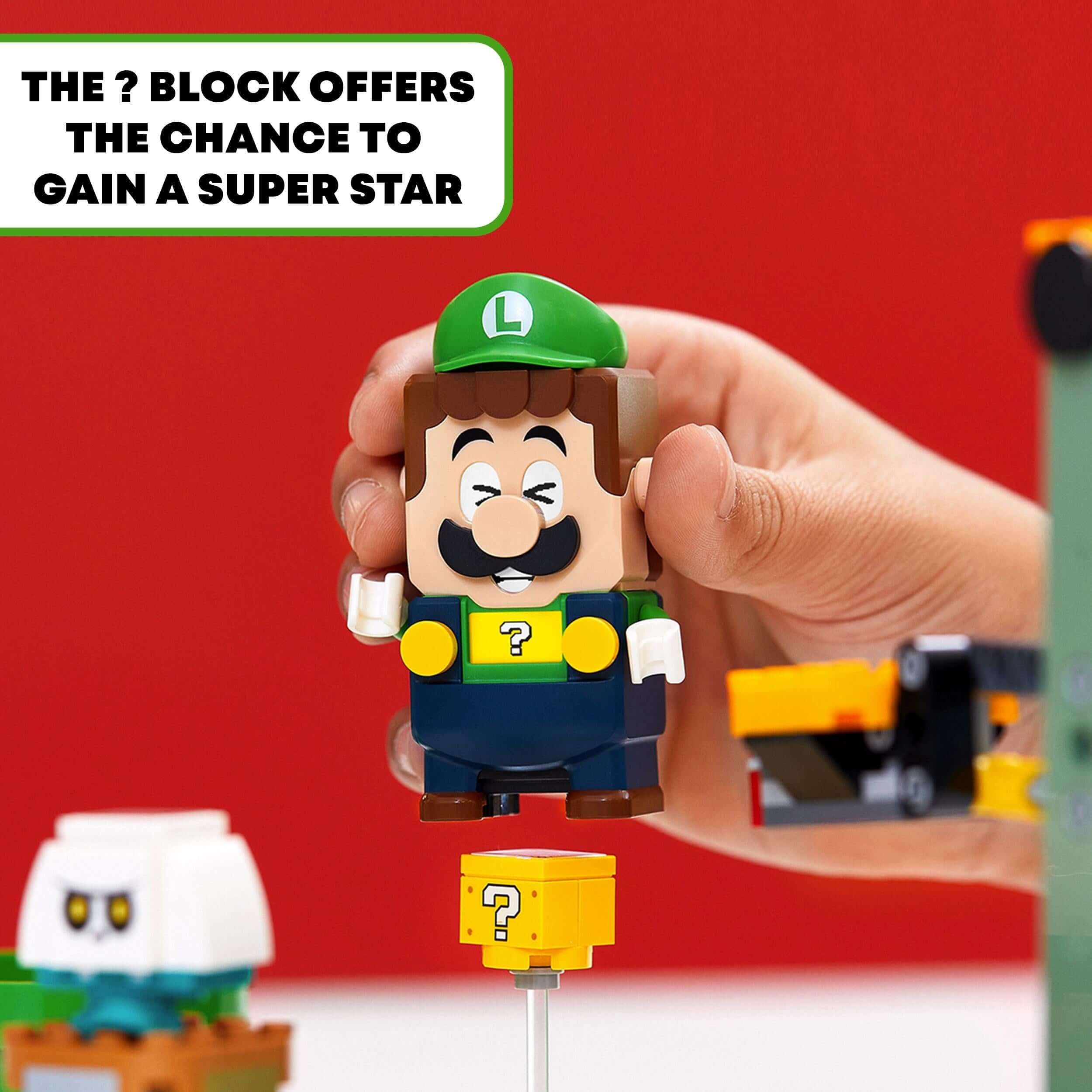 LEGO® Super Mario Luigi figure interacting with a ? block to gain a super star in the starter course set.