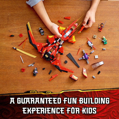 Kids enjoying a fun building experience with LEGO NINJAGO Legacy Kai Fighter Toy Jet 71704 set, surrounded by colorful pieces.