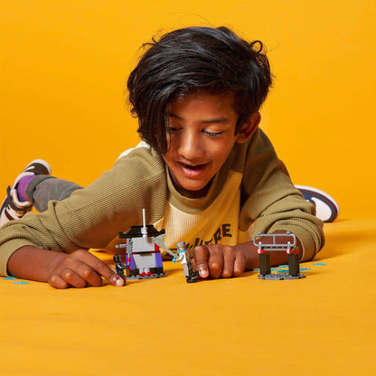 Child enjoying playtime with LEGO NINJAGO Epic Battle Set Zane vs. Nindroid 71731 on a bright yellow background.
