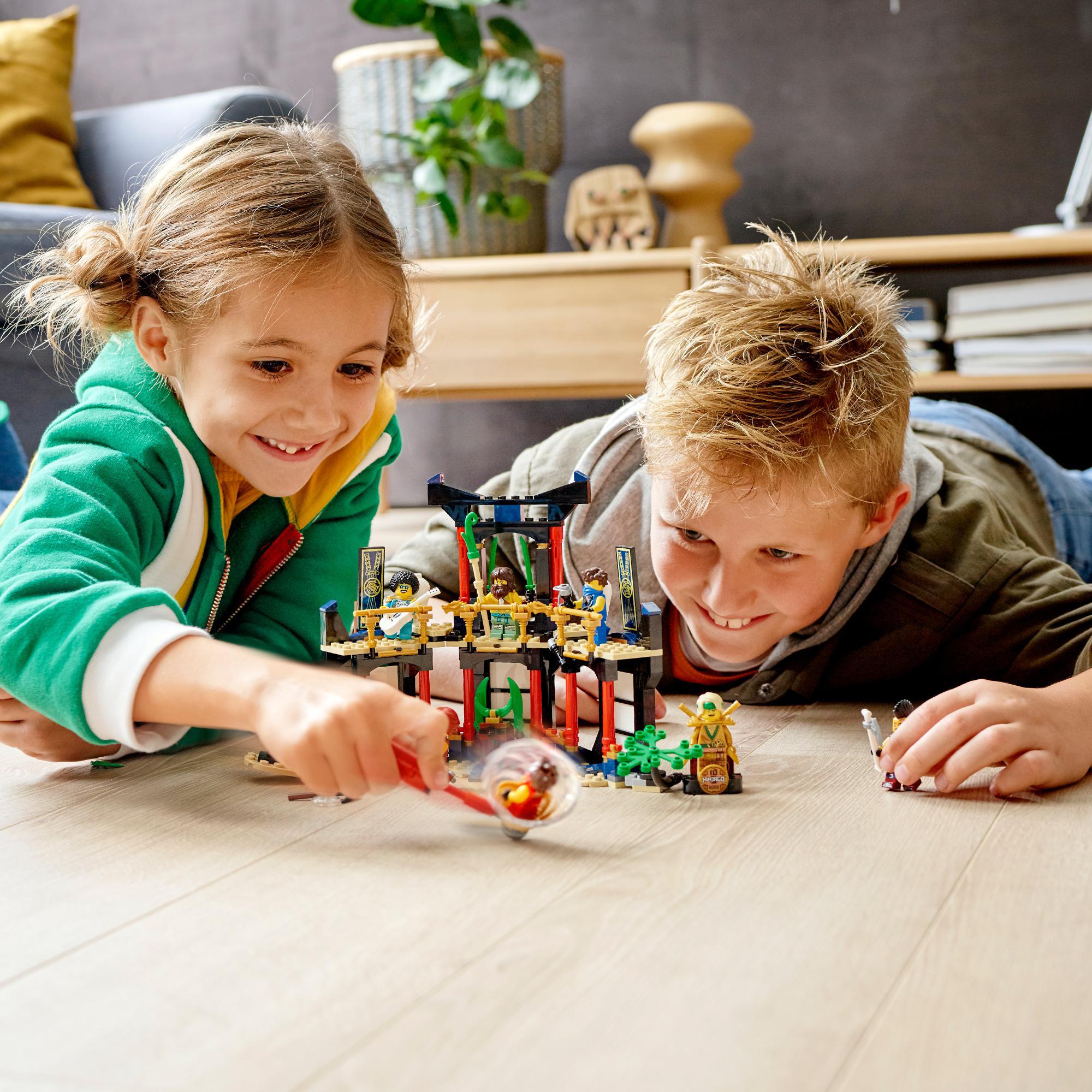 Kids playing with LEGO® NINJAGO Legacy Tournament of Elements Set 71735, enjoying ninja battles and roleplay.