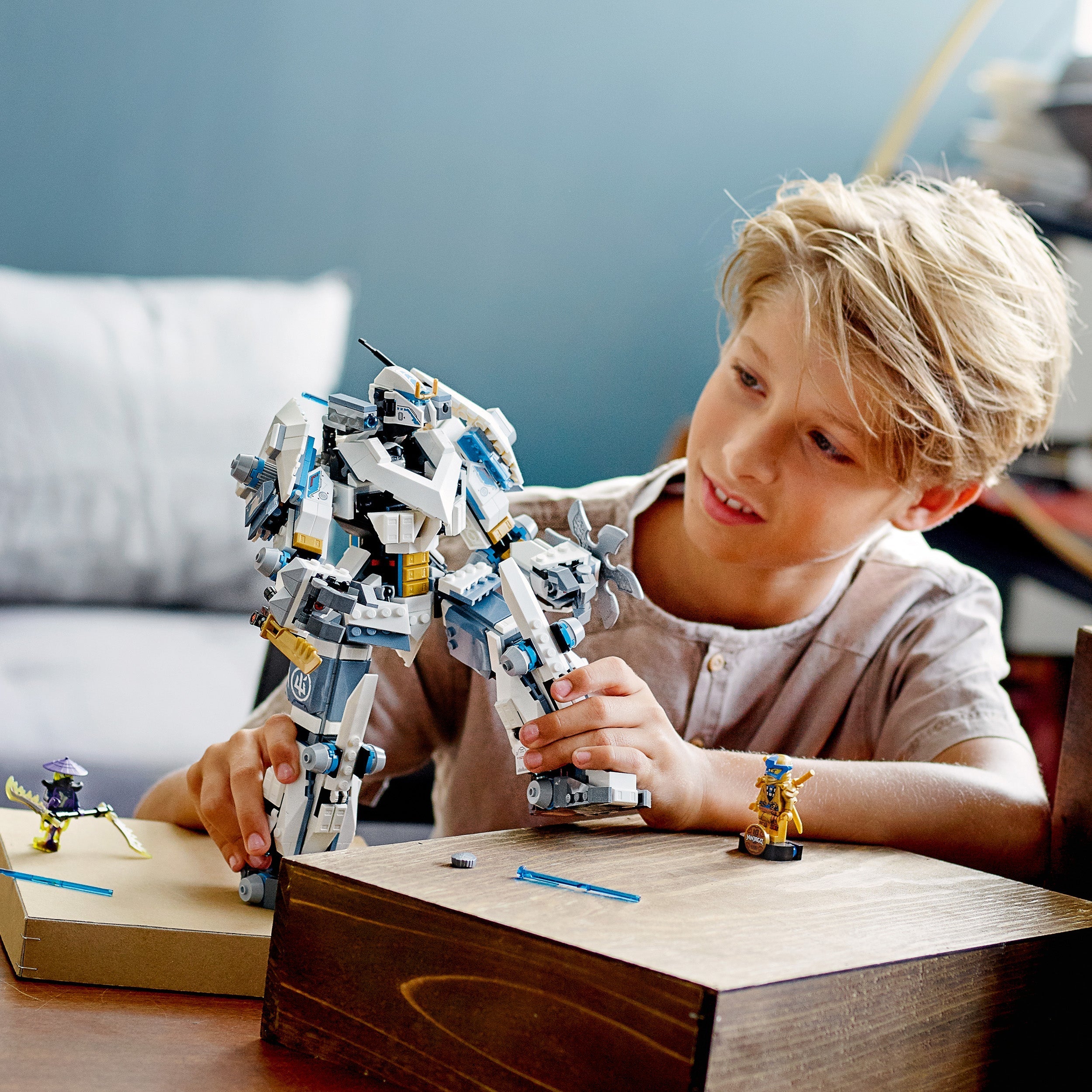 Child playing with LEGO® NINJAGO Zane’s Titan Mech toy 71738, showcasing creativity and adventure.