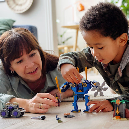 Child and adult building with LEGO® NINJAGO Legacy Jay’s Electro Mech toy playset on the floor.