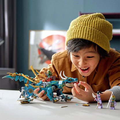 Child playing with LEGO® NINJAGO Jungle Dragon toy set 71746, showcasing excitement and creativity with minifigures.