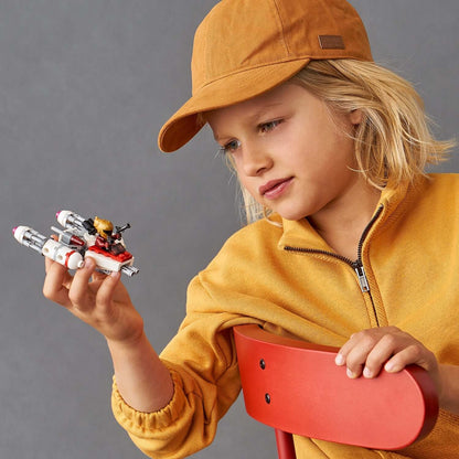 Child exploring LEGO Star Wars Resistance Y-wing Microfighter, showcasing creativity and role-play fun.