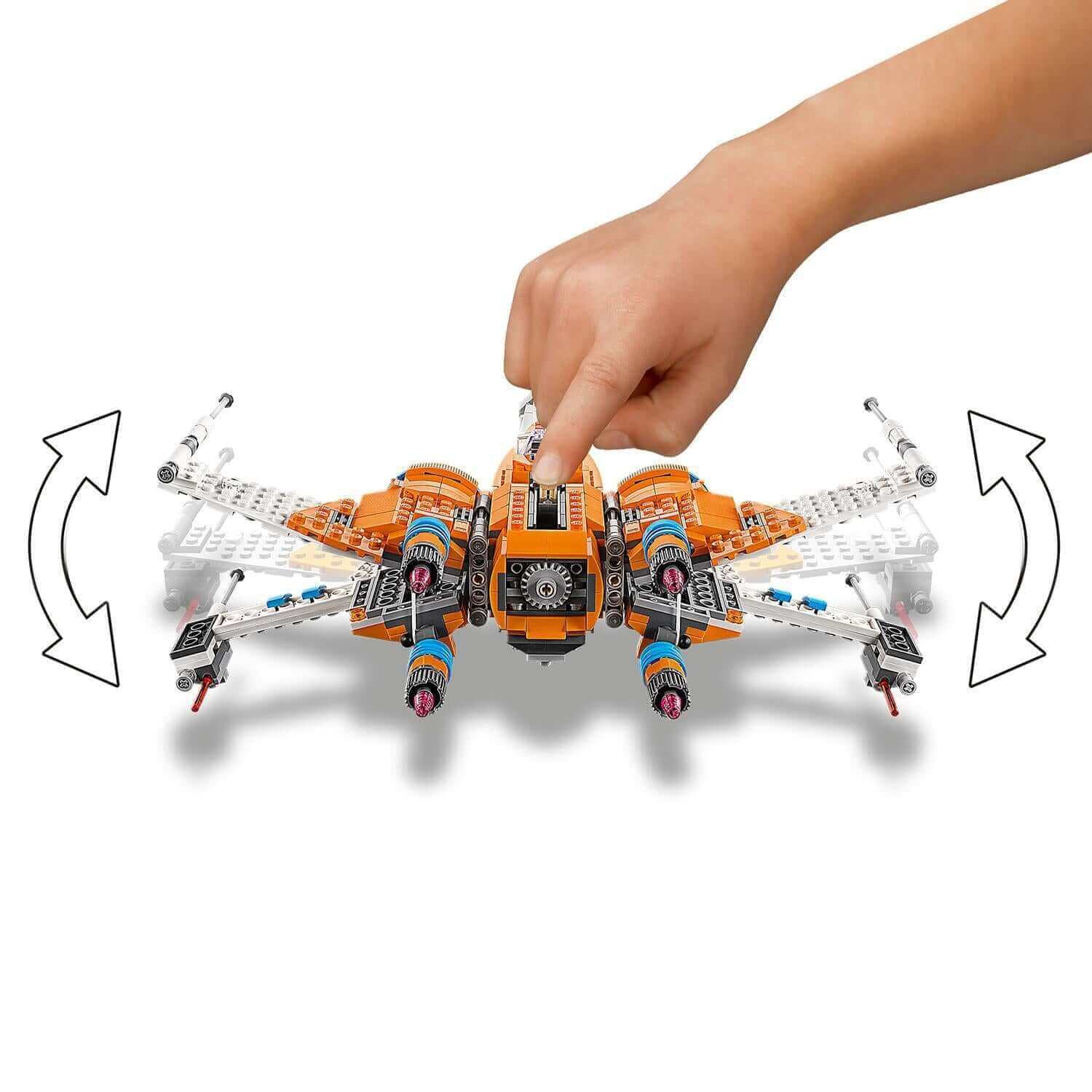 Child adjusting the rotating engines of the LEGO® Star Wars Poe Dameron's X-wing Fighter 75273 building set.