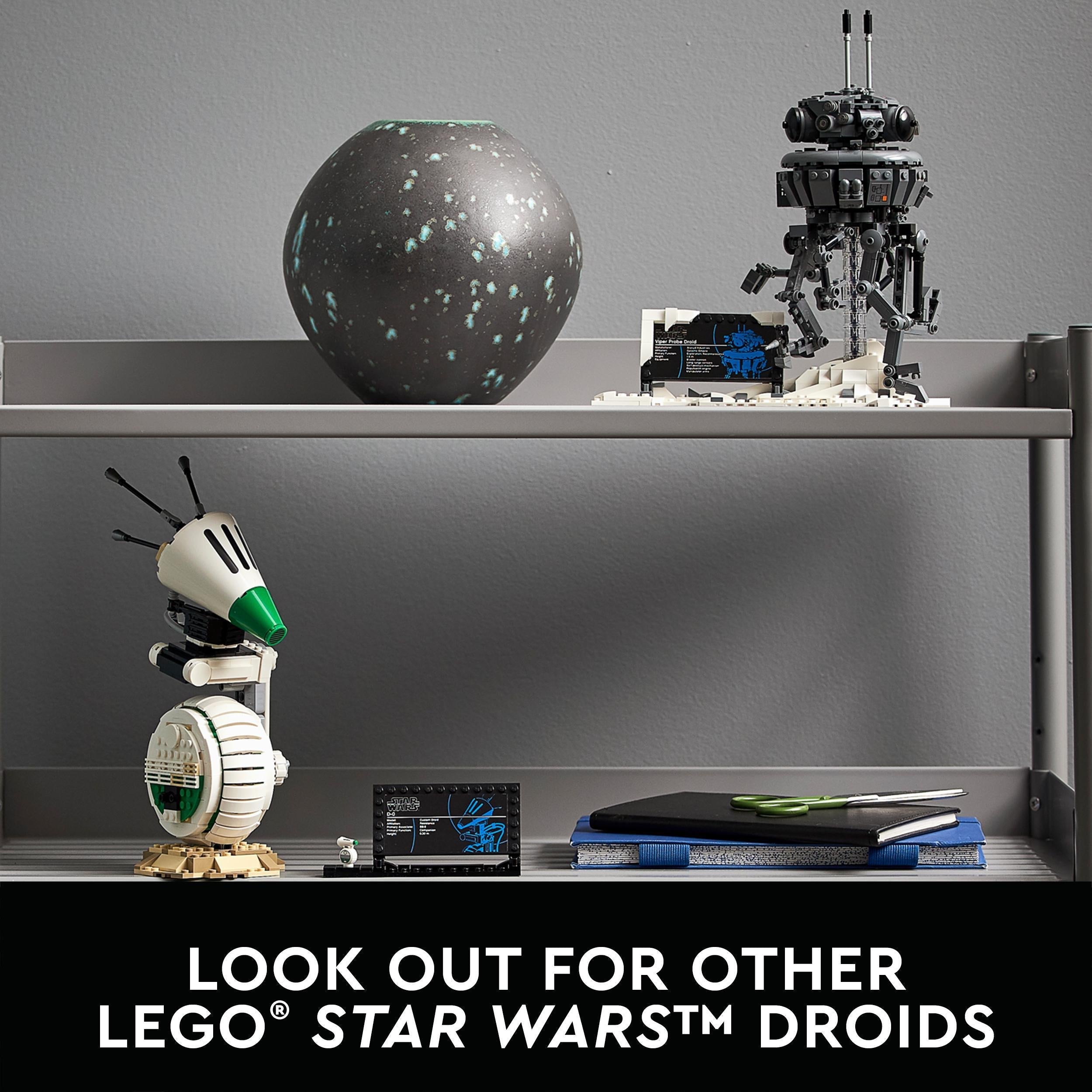 LEGO® Star Wars Imperial Probe Droid and other droids displayed on a shelf with decorative vase and notebook.