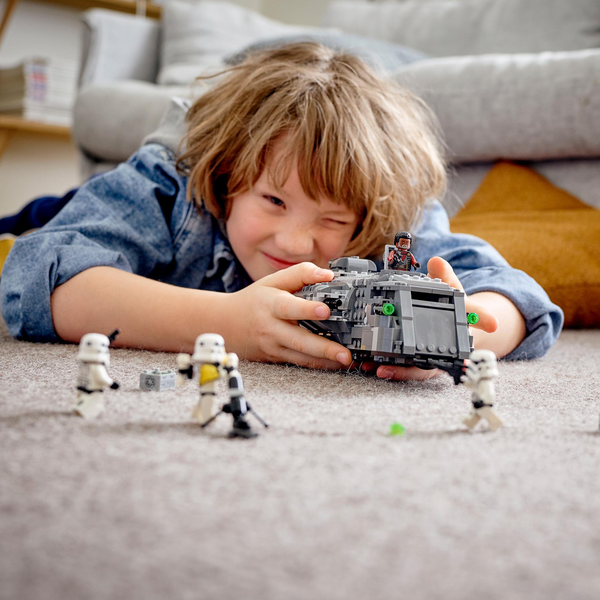 Child playing with LEGO® Star Wars Imperial Armoured Marauder Set 75311, roleplaying Stormtroopers vs. Greef Karga.