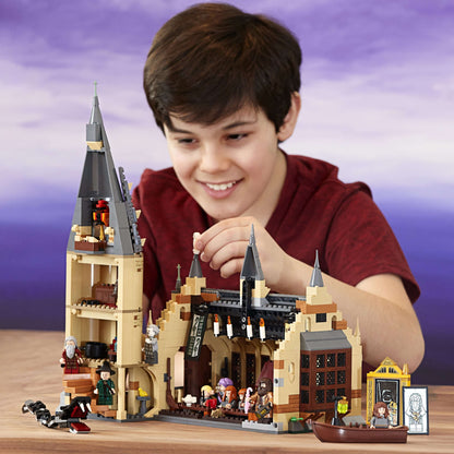 Child building the LEGO® Harry Potter Great Hall Castle Set 75954, showcasing creativity and playfulness.