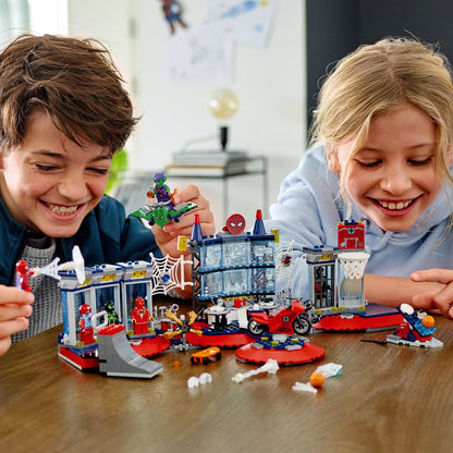 Kids enjoying LEGO® Marvel Spider-Man Attack on the Spider Lair set, featuring playful superhero action.