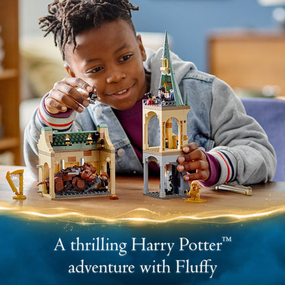 Child playing with LEGO Harry Potter Fluffy Encounter set, featuring Hogwarts, magical figures, and thrilling adventure.