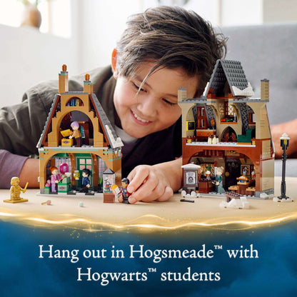 Child interacting with LEGO Harry Potter Hogsmeade Village Set featuring Hogwarts students, ideal for magical roleplay.
