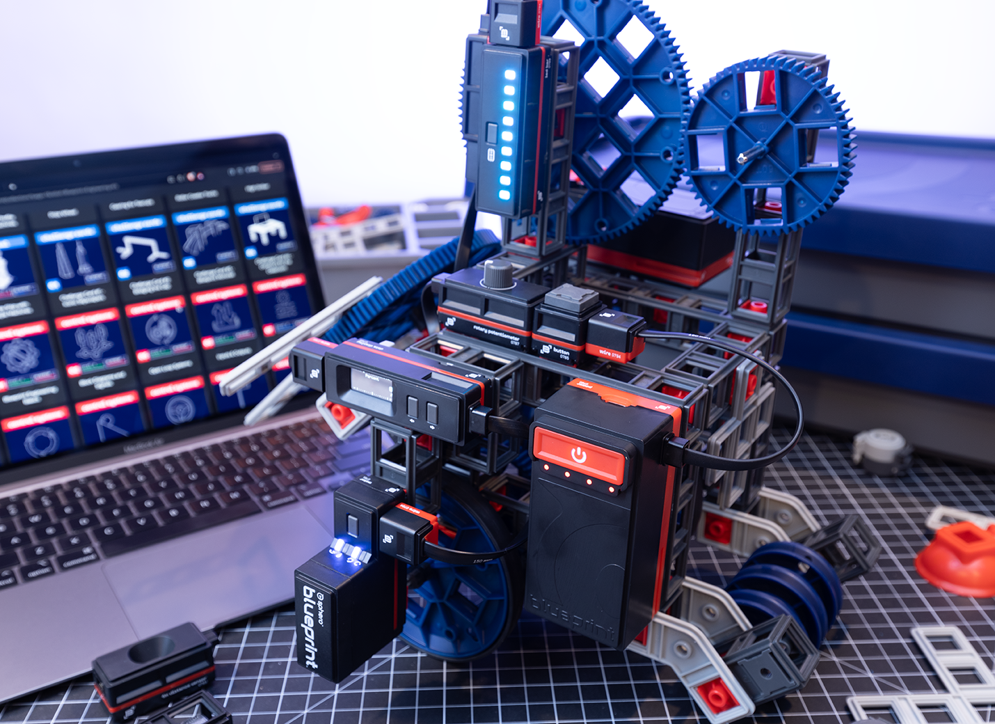 Blueprint Engineering Class Pack showcasing a robotic kit with gears and a laptop displaying engineering resources.