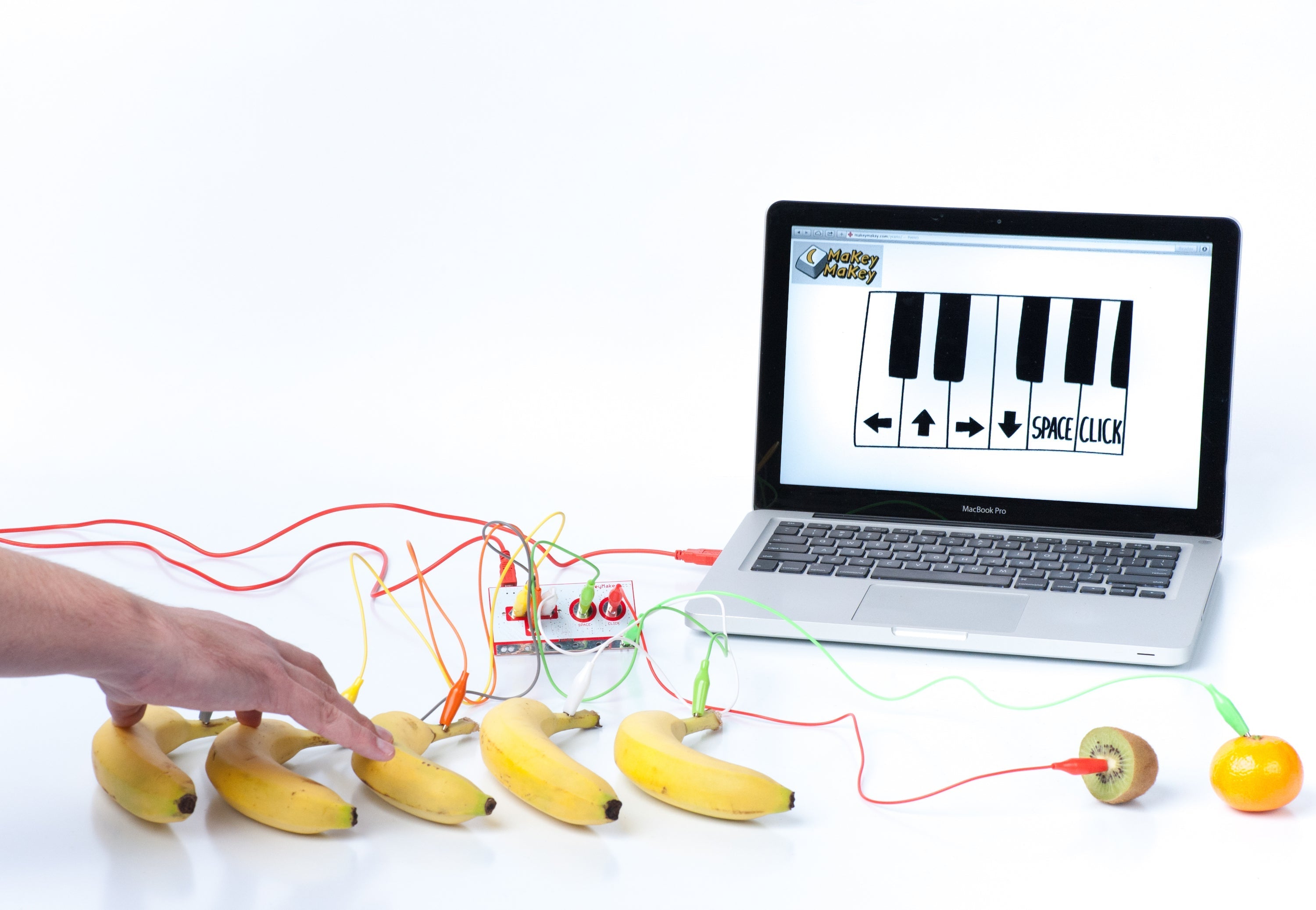 Image of bananas used as piano keys connecting to a laptop running a music interface for Makey Makey® kit.