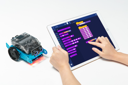 Student programming the Makeblock mBot 2 robot with a tablet interface for educational purposes.