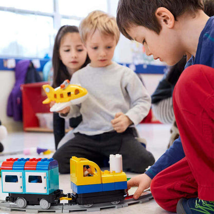 Children engaged in play with LEGO Education Coding Express 45025 train set, fostering early coding skills and creativity.