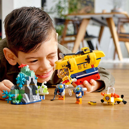 Boy playing with LEGO® City Ocean Exploration Submarine Sea Set 60264 featuring submarine and marine life.