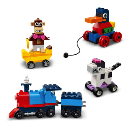 Colorful LEGO® Classic Bricks and Wheels playset with a monkey, duck, train, and cow models for creative building.