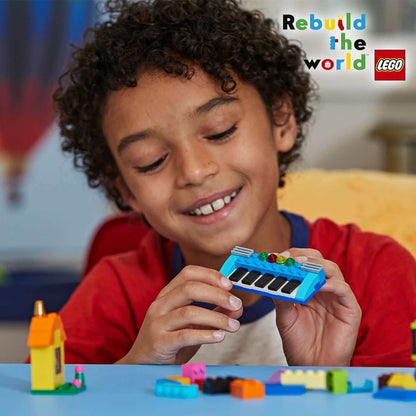 Child enjoying LEGO® Classic Bricks and Ideas toy, building colorful creations in a playful environment.