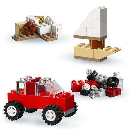 Colorful LEGO® pieces in various shapes, including a red car, for creative building in the LEGO® Classic Creative Suitcase.