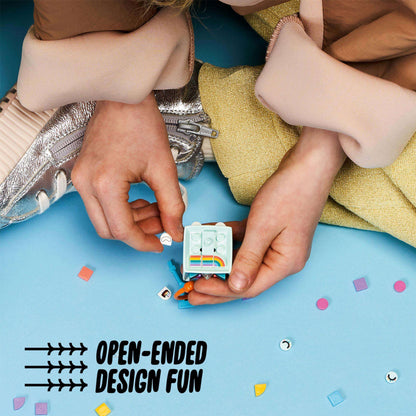 Child creatively designing a LEGO® DOTS Unicorn bag tag kit on a colorful surface with playful tiles.