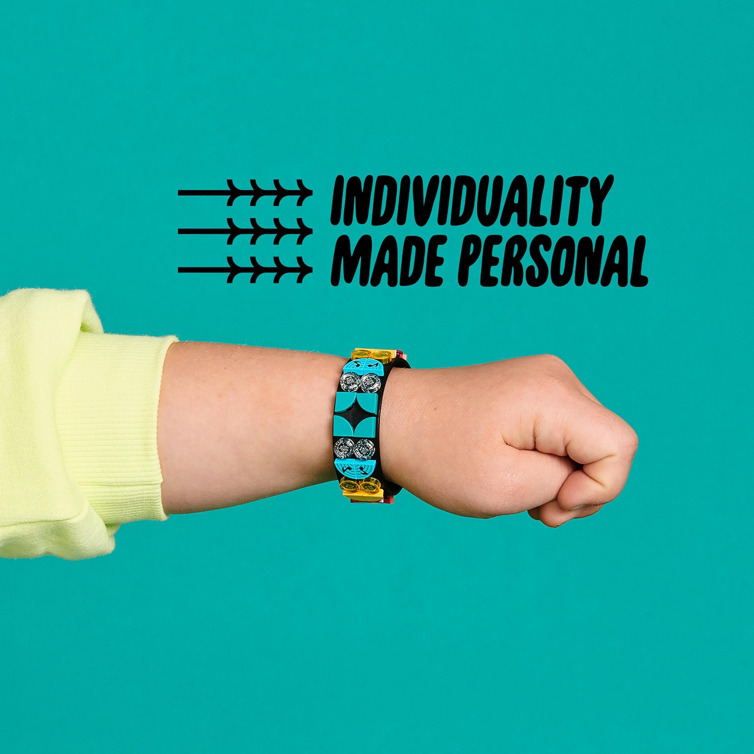 Child's hand wearing a LEGO® DOTS music bracelet, showcasing vibrant tiles and personalization with individuality theme.