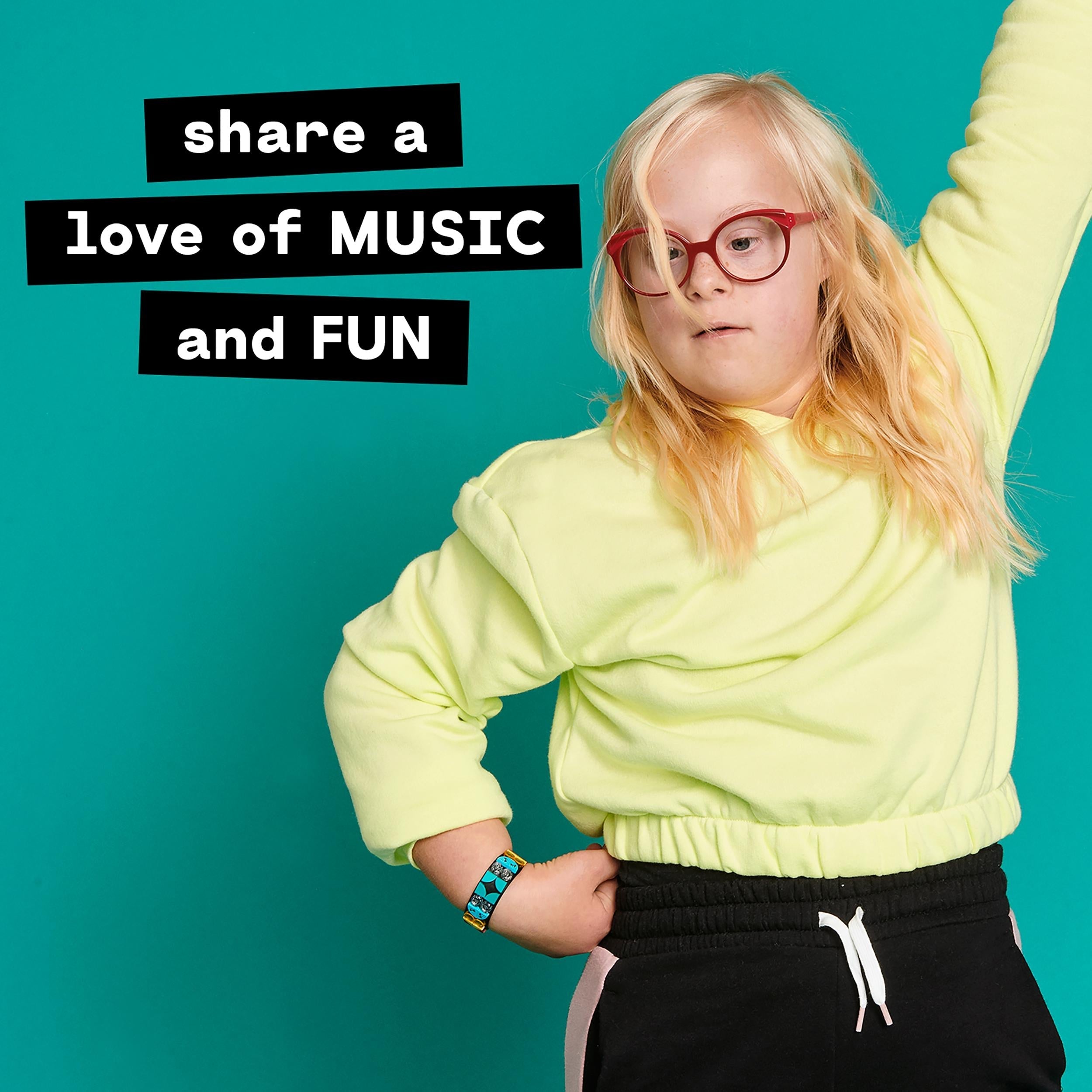 Child wearing a LEGO® DOTS Music Bracelet, showcasing creativity and fun in a vibrant setting.
