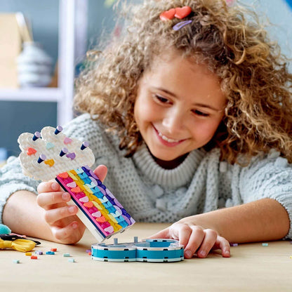 Child enjoying LEGO® DOTS Rainbow Jewellery Stand set, crafting jewelry in a creative and playful setting.