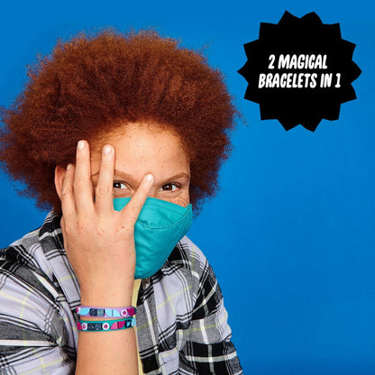 Child wearing teal mask, showing off LEGO® DOTS Starlight Bracelets, featuring colorful magnetic designs.