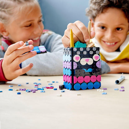Kids creating with LEGO® DOTS Secret Holder set, building colorful designs with fun tiles and showcasing creativity.
